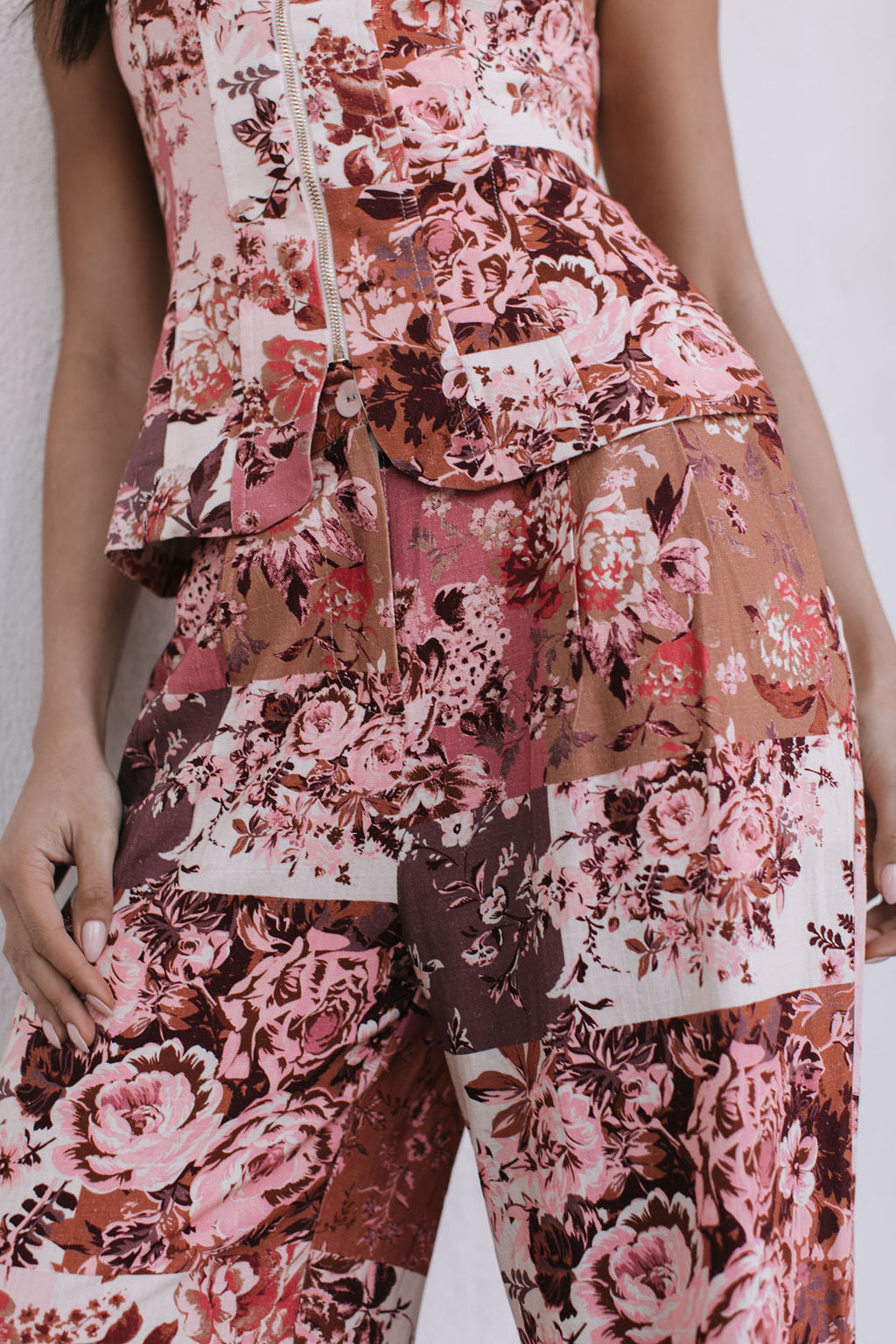 Floral patterned outfit with a top and pants on a plain background