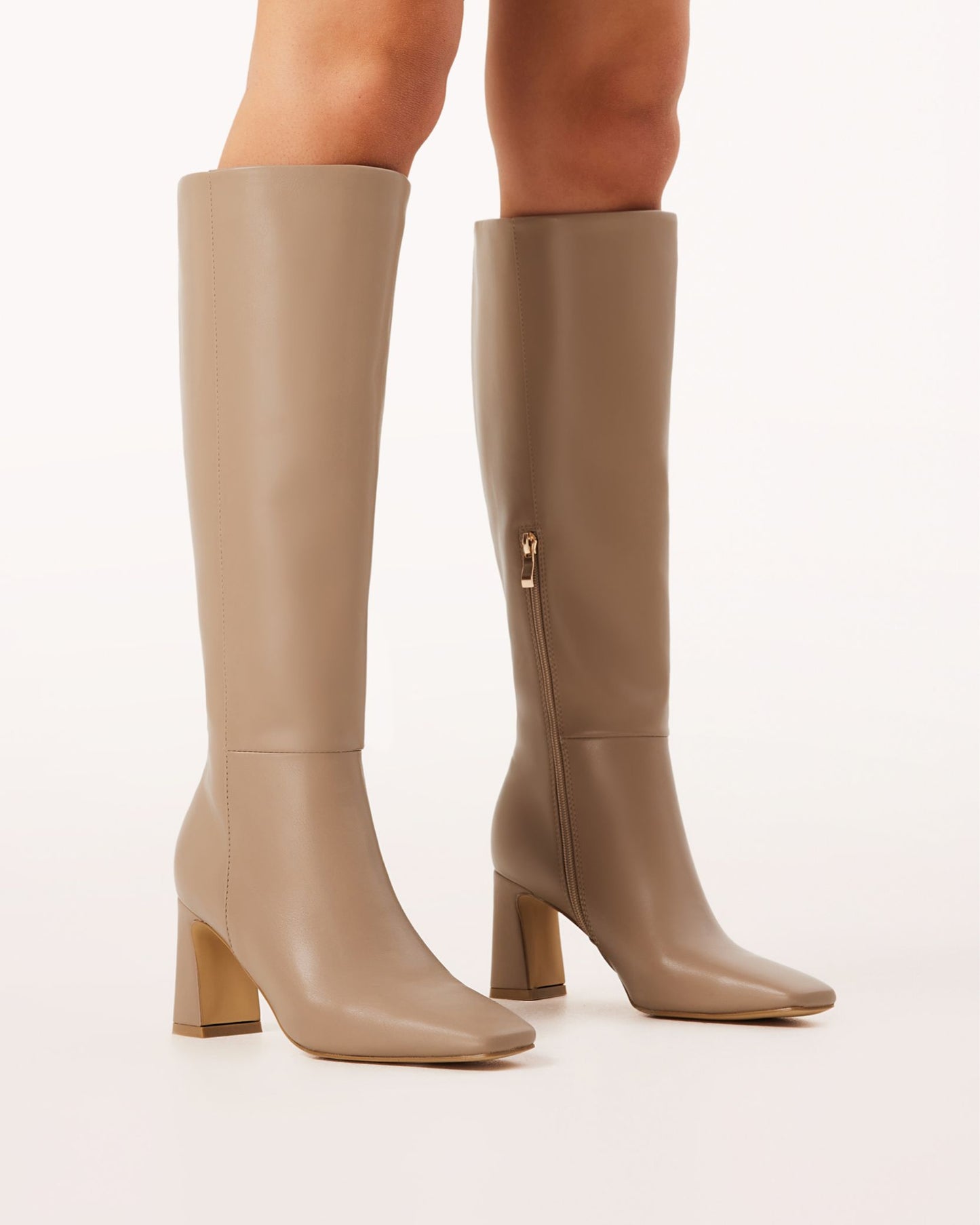 A pair of knee-high boots in a truffle brown tone with a block heel and square toe.