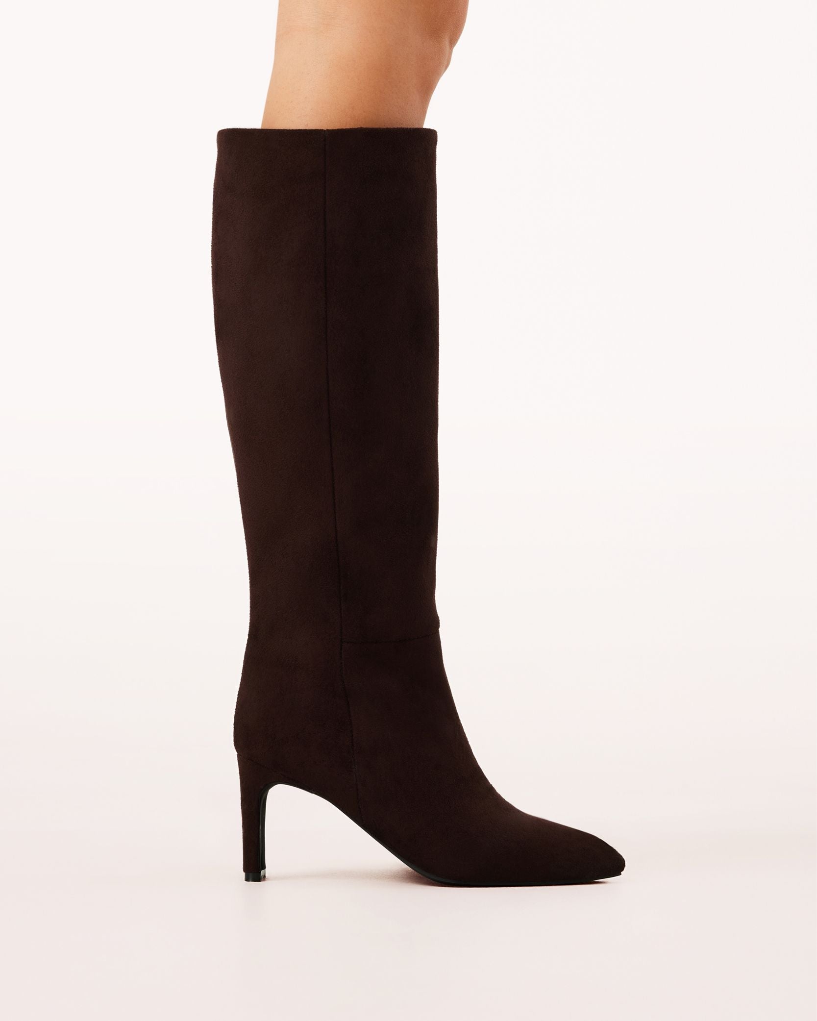 A chocolate brown suede knee-high boot with a pointed toe and high heel.