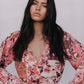 Woman wearing a floral blouse with a blurred background
