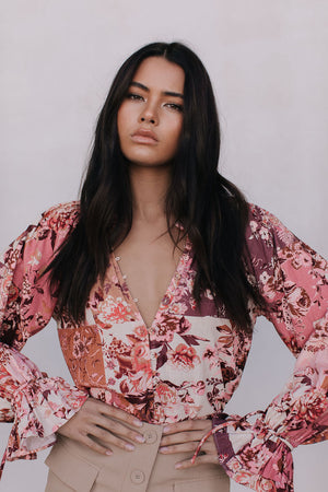 Woman wearing a floral blouse with a blurred background