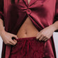 Burgundy satin top and lace pants on a white background