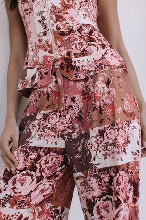 Floral patterned outfit with a top and pants on a plain background