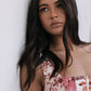 Woman wearing a floral dress against a white background