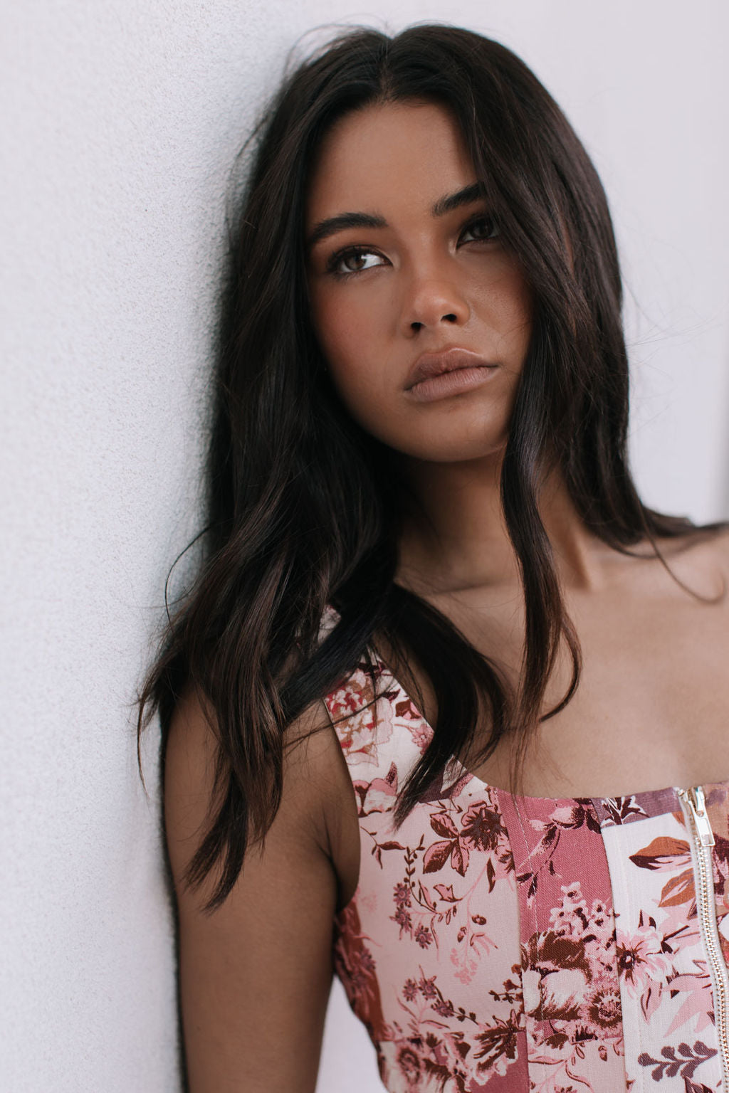 Woman wearing a floral dress against a white background