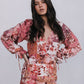 Woman wearing a floral dress against a plain background