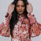 Woman wearing a floral patterned dress against a plain background