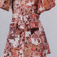 Floral patterned dress with puffed sleeves on a plain background