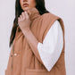 Woman wearing a brown puffer vest over a white shirt against a white background